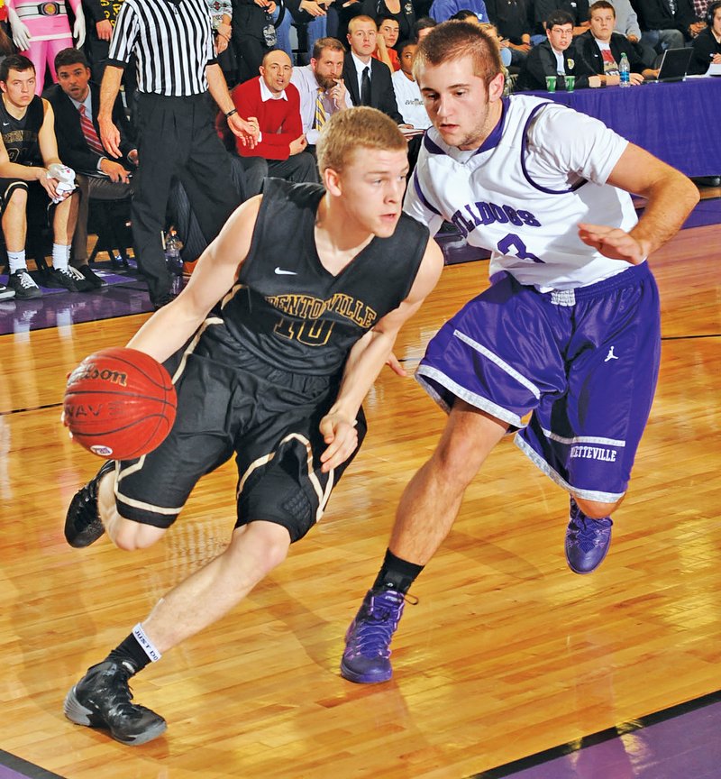 FILE PHOTO ANDY SHUPE Jake Caudle, left, of Bentonville drives Feb. 28 against Fayetteville's Mason Adams. Caudle may have provided Bentonville with its most pleasant surprise with his play during the season.