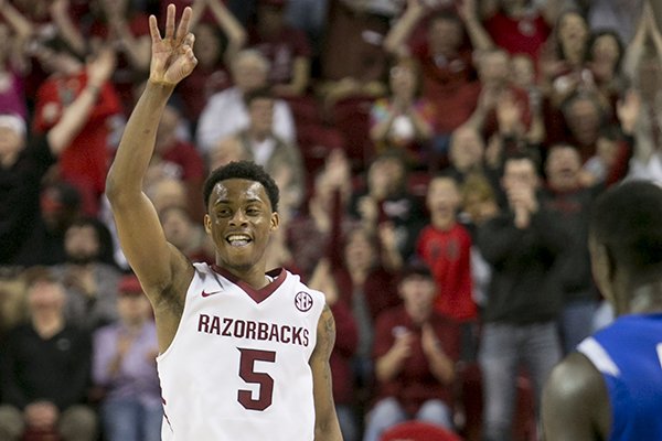 Arkansas guard Anthlon Bell (5) celebrates after shooting a three-pointer against Indiana State guard Manny Arop (3) during the second half of an opening round National Invitational Tournament NCAA college basketball game in Fayetteville, Ark., Tuesday, March 18, 2014. Bell led all scorers with 28 as Arkansas defeated Indiana State 91-61. (AP Photo/Gareth Patterson)