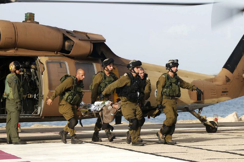 A wounded Israeli soldier is taken to a hospital in Haifa, Israel, on Tuesday. A roadside bomb hit an Israeli patrol in the Golan Heights on Tuesday, the army said, wounding four soldiers. 