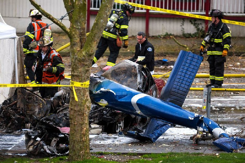 Investigators and emergency personnel look over the aftermath of a news helicopter crash Tuesday in Seattle. 