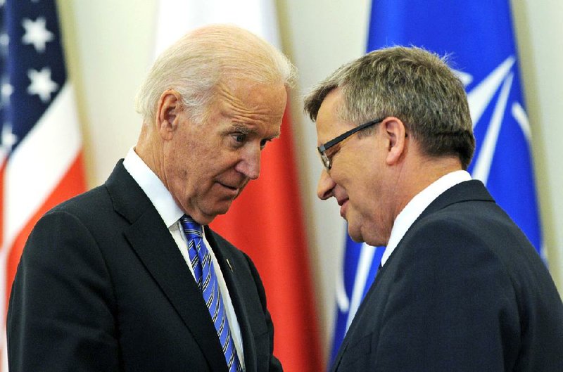 Vice President Joe Biden talks with Polish President Bronislav Komorowski after a news conference Tuesday in Warsaw. Biden said “the world has seen through Russia’s actions.” 