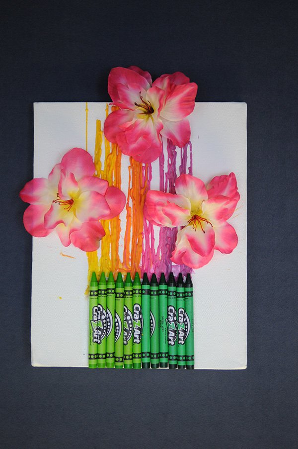 STAFF PHOTO SPENCER TIREY 
Bright crayon colors and flowers make for a fun and funky spring-inspired craft project. Perfect to brighten up a small space, the colorful canvas invites warmth into the home during the final chilly days of a Northwest Arkansas winter.