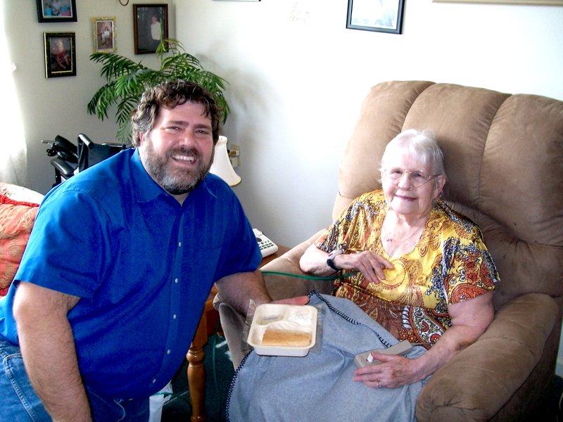 Submitted Photo Gravette Mayor Byron Warren is pictured with Shirley Clark, who is enjoying the meal he delivered.