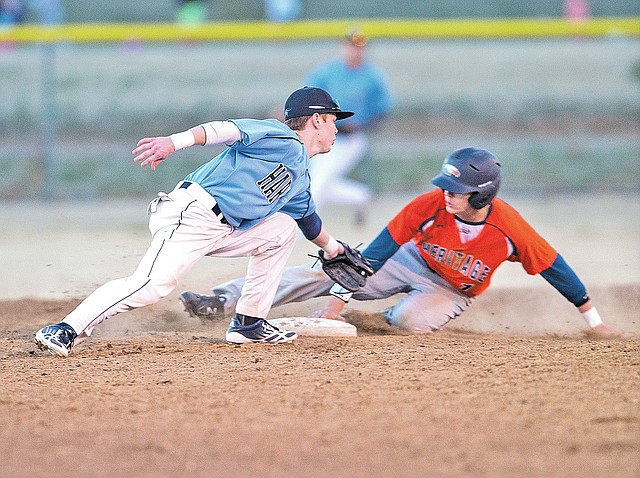  STAFF PHOTO ANTHONY REYES Holden Thornton of Springdale Har-Ber tries to tag Ty Harris of Rogers Heritage out at second Tuesday during Game 2 of a doubleheader at Tyson Sports Complex in Springdale. Harris was safe on the play.