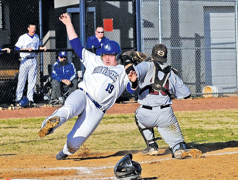  STAFF PHOTO FLIP PUTTHOFF Josh Poulos, right, Springdale Bulldogs catcher tries to tag Rogers' Bryce Bray, but Bray was safe at home plate to score the game-ending run in Game 1 of the teams doubleheader.