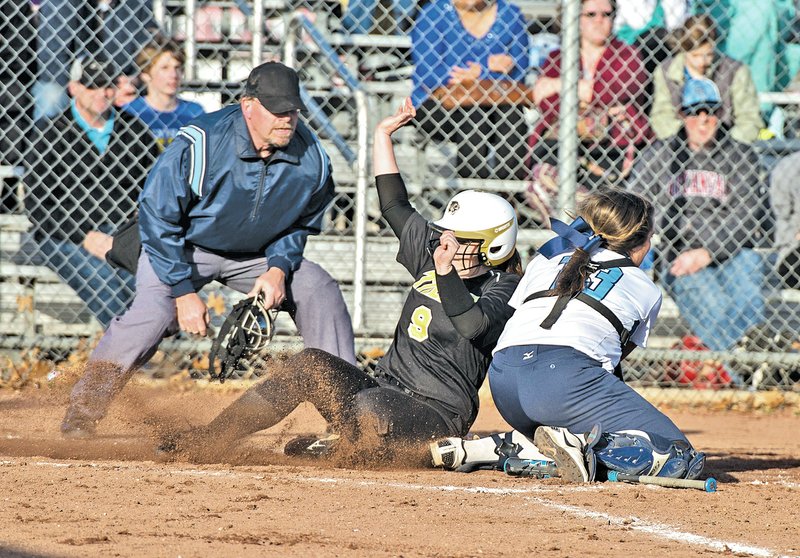  STAFF PHOTO ANTHONY REYES Tiffani Ray of Springdale Har-Ber tags out Alicia Lowrey of Bentonville on Tuesday at home at J.B. Hunt Park in Springdale.