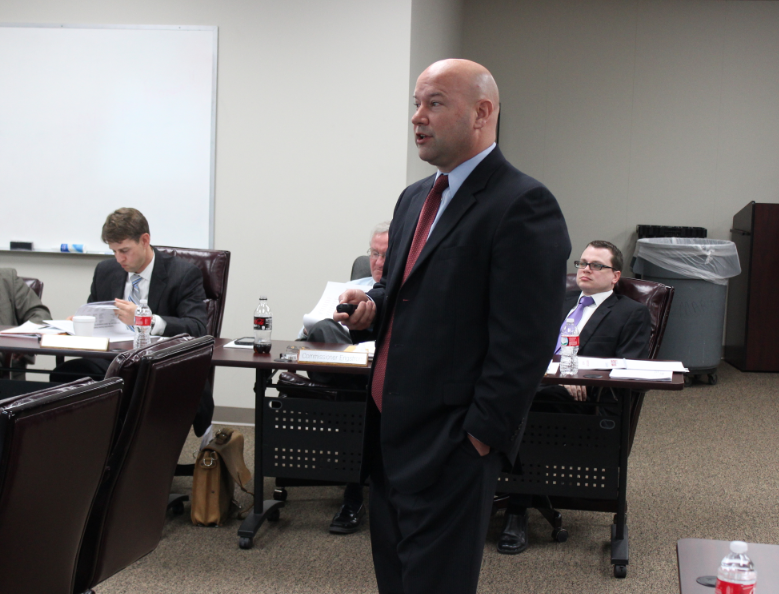 Arkansas Scholarship Lottery Director Bishop Woosley gives a report to the lottery commission Wednesday.