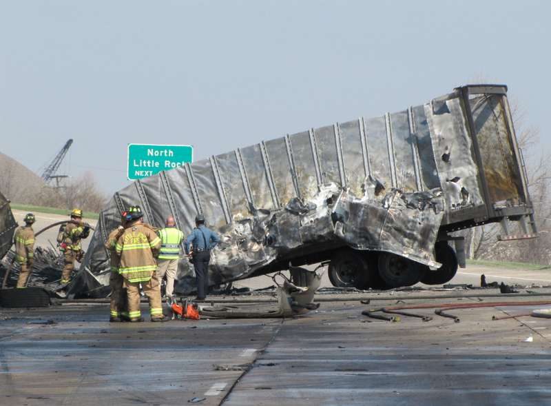 Firefighters work around the wreckage of a truck that caught fire in a wreck Wednesday on Interstate 440 in Little Rock.