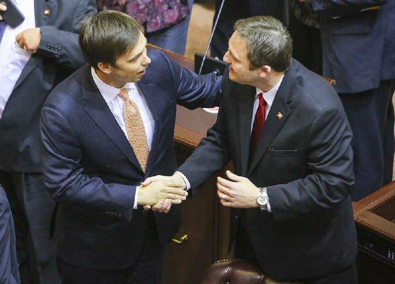 House Speaker Davy Carter (left) congratulates his successor-elect Rep. Jeremy Gillam in the House on Wednesday. 