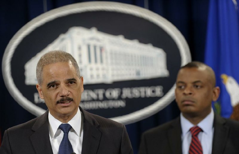 Attorney General Eric Holder (left) and Transportation Secretary Anthony Foxx announce Wednesday in Washington the $1.2 billion settlement with Toyota Motor Corp., and the filing of a criminal case over Toyota’s actions concerning safety problems. 