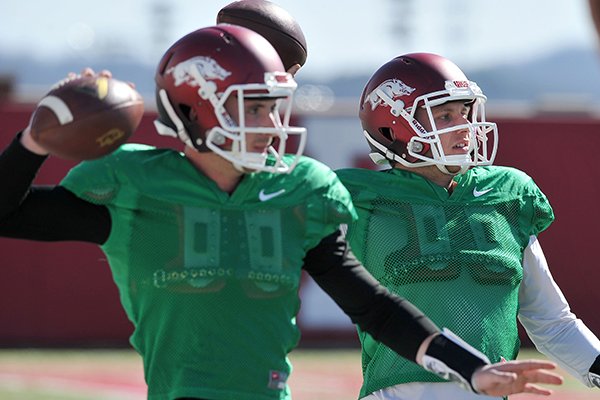 Arkansas quarterbacks Brandon Allen (left) and Austin Allen run drills during practice Thursday afternoon in Fayetteville.