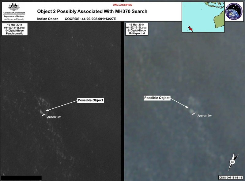 In this March 16, 2014, satellite imagery provided by Commonwealth of Australia Department of Defence on Thursday, March 20, 2014, a floating object is seen at sea next to the descriptor which was added by the source. Australia's government reported Thursday, March 20, 2014, that the images show suspected debris from the missing Malaysia Airlines jetliner floating in an area 1,550 miles southwest of Perth Australia. 