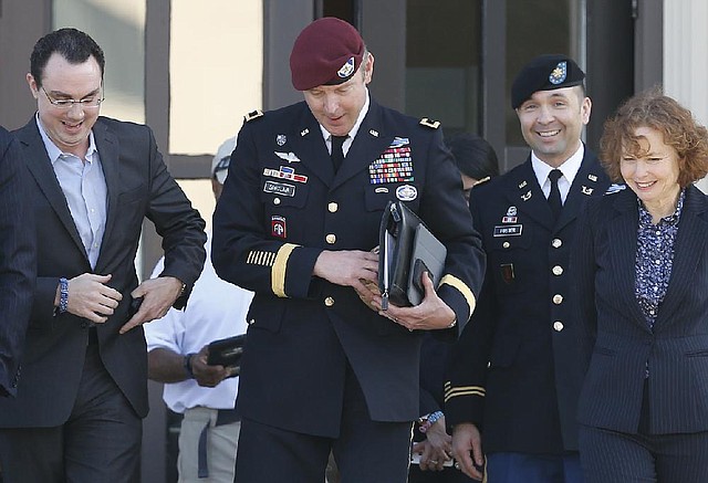 Brig. Gen. Jeffrey Sinclair, center, who admitted to inappropriate relationships with three subordinates, leaves the courthouse after being sentenced at Fort Bragg, N.C., Thursday, March 20, 2014. Attorneys Ellen Brotman, right, and Maj. Sean Foster, along with Josh Zeitz, left, who handled Public Relations for the defense, are by his side.  Sinclair was reprimanded and docked $20,000 in pay Thursday, avoiding jail time in one of the U.S. military's most closely watched courts-martial. (AP Photo/Ellen Ozier)