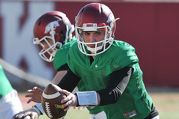 Arkansas quarterback Brandon Allen runs drills during practice Thursday, March 20, 2014 in Fayetteville.