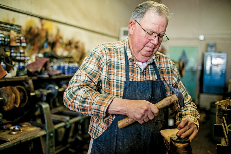 Above: David Garner of Johns Shoe Hospital in Hot Springs tacks a heel onto a boot in the shoe shop where he said his peak season coincides with the horse racing season at Oaklawn Park. Below: Garner, who has been in the business of repairing shoes and boots in Hot Springs since 1955, uses one of the tools of his trade to work on a boot heel.