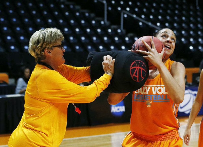 Tennessee head coach Holly Warlick works with forward Cierra Burdick (11) during practice for the NCAA women's college basketball tournament Friday, March 21, 2014, in Knoxville, Tn. (AP Photo/John Bazemore)