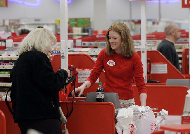 FILE - In this  Friday, Nov. 18, 2005, file photoCashier Nora Poage rings up a purchase at a Target store in Seattle Wash.  A federal appeals court has handed a defeat to a coalition of retail groups that challenged as too high the Federal Reserve's cap on how much banks can charge businesses for handling debit card transactions. The ruling issued Friday, March 21, 2014 by the U.S. Appeals Court for the District of Columbia overturned a lower court's decision in July that favored the merchants and was a setback for banks. (AP Photo/Ted S. Warren, File)
