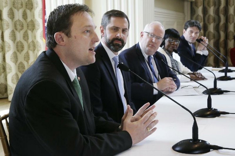 Arkansas House Speaker-designate Jeremy Gillam, R-Judsonia, far left, speaks at a meeting of the Political Animals Club in Little Rock, Ark., as, from left, Rep. Greg Leding, D-Fayetteville, club president Rex Nelson, Sen. Linda Chesterfield, D-Little Rock, and Sen. David Sanders, R-Little Rock listen Friday, March 21, 2014. The panel discussed recent reauthorization of the state's "private option" during this year's legislative session. (AP Photo/Danny Johnston)