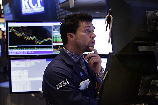 Specialist Joseph Dreyer works at his post on the floor of the New York Stock Exchange, Friday, March 21, 2014. Signs that the U.S. economy is emerging from a winter chill drove major stock indexes higher Thursday. Investors were encouraged by an increase in manufacturing and a rise in a key index of economic indicators. (AP Photo/Richard Drew)