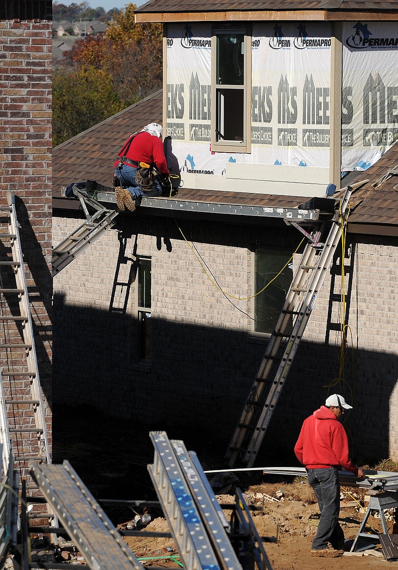 FILE PHOTO &#8212; Workers construct a house in the Kerelaw Castle Subdivision in Bentonville last November.Paul Bynum, owner and principal broker of real estate data firm MountData, said in his annual home sales report for 2013 that the area&#8217;s low unemployment rate and growing population, along with low interest rates, will help the real estate market.