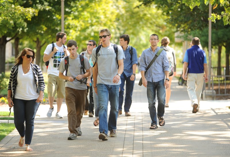 FILE PHOTO &#8212; University of Arkansas students walk to and from classes on campus in Fayetteville. The University of Arkansas at Fayetteville enrolled 25,341 last fall. Students represent all 50 states and 120 countries, according to the university.