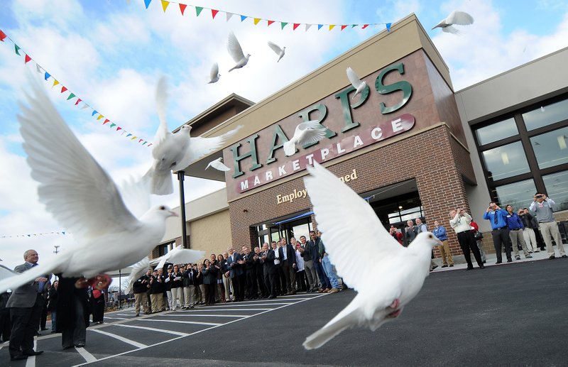 FILE PHOTO &#8212; Doves take flight during grand opening ceremonies last year for the new Harps Marketplace on North Walton Boulevard in Bentonville. Harps Food Stores, Inc., is among those competing with Walmart in Northwest Arkansas.