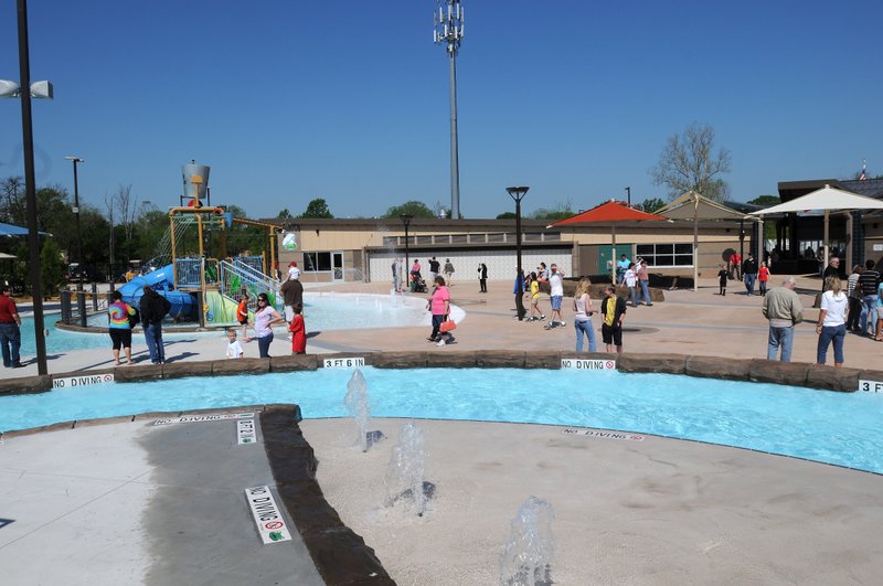 FILE PHOTO &#8212; Local residents tour the Rogers Aquatics Center last year a few days before it opened in May. The center, just north of West New Hope Road, cost $13 million to build.