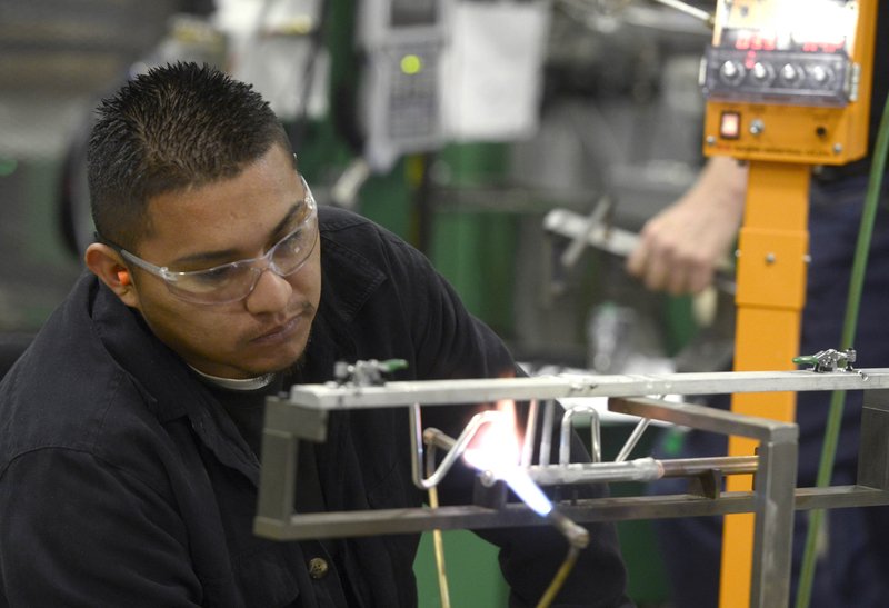FILE PHOTO &#8212; Jose Rodriguez with American Tubing brazes a section of aluminum tubing last November at the company factory in Springdale. American Tubing recently announced an expansion at their plant in Springdale.