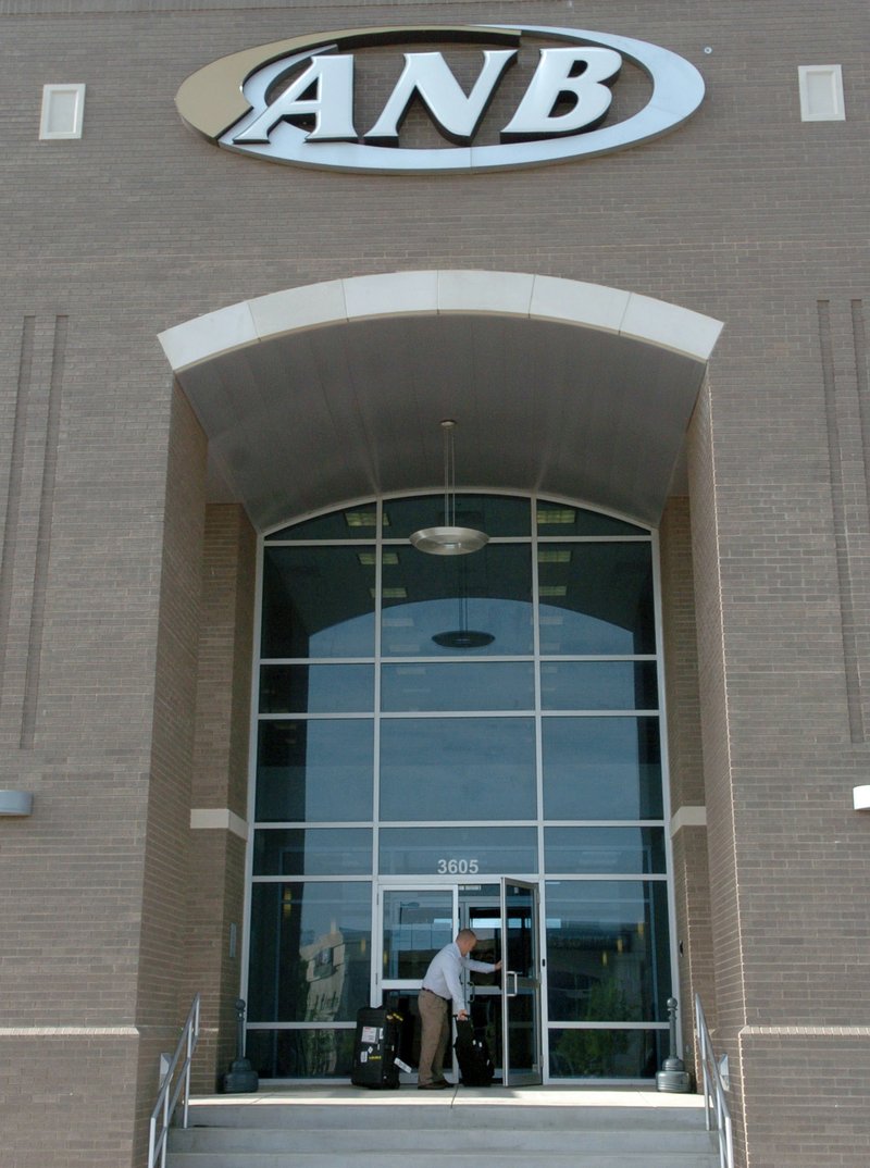 FILE PHOTO &#8212; A Federal Insurance Deposit Corp., employee enters the Arkansas National Bank building in Rogers on May 2008 after the bank failed. ANB Financial of Bentonville reopened the next week under a new owner.