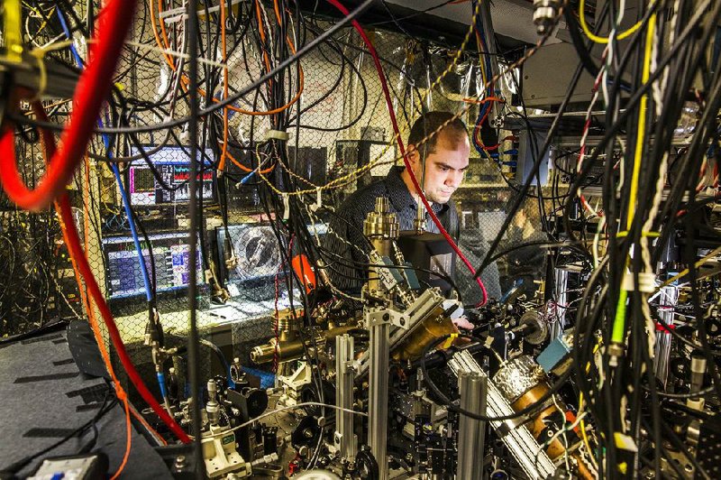 Graduate student David Hucul adjusts laser optics on an ion trap quantum experiment at the University of Maryland. Lockheed Martin and the university are collaborating on harnessing the potential of quantum computing. Illustrates COMPUTERS-QUANTUM (category a), by Mohana Ravindranath (c) 2014, The Washington Post. Moved Tuesday, March 17, 2014. (MUST CREDIT: Jeffrey MacMillan)