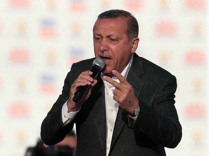 Turkish Prime Minister Recep Tayyip Erdogan addresses supporters of his Justice and Development Party during a rally in Istanbul, Turkey, Sunday, March 23, 2014. Turkish fighter jets shot down a Syrian warplane after it violated Turkey's airspace Sunday, Erdogan said, in a move likely to ramp up tensions between the two countries already deeply at odds over Syria's civil war. Erdogan is fighting corruption allegations against his government a week before local elections that are seen as a referendum over his rule. (AP Photo/Emrah Gurel)