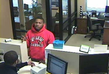Little Rock Police Department officials say the man pictured robbed the Iberia Bank branch at 4900 W. Markham St. about 4 p.m. Monday, March 24, 2014. He's described as a young black male wearing red hooded sweatshirt. 