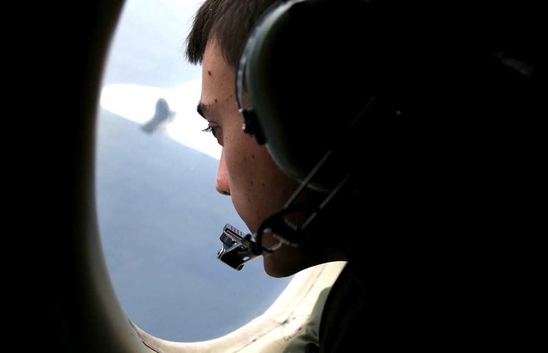 In this March 22, 2014, file photo, Sgt. Matthew Falanga on board a Royal Australian Air Force AP-3C Orion, search for the missing Malaysia Airlines flight MH370 in southern Indian Ocean, Australia. Not one object has been recovered from the missing airliner that Malaysian officials are now convinced plunged into the southern Indian Ocean 17 days ago. 