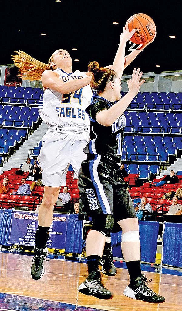 COURTESY PHOTO 
Brooke Barker, left, John Brown sophomore, drives to the basket and is fouled by Oklahoma City’s Kayla McKenzie during Monday’s NAIA Division I Women’s National Tournament semifinals at Frankfort (Ky.) Convention Center.