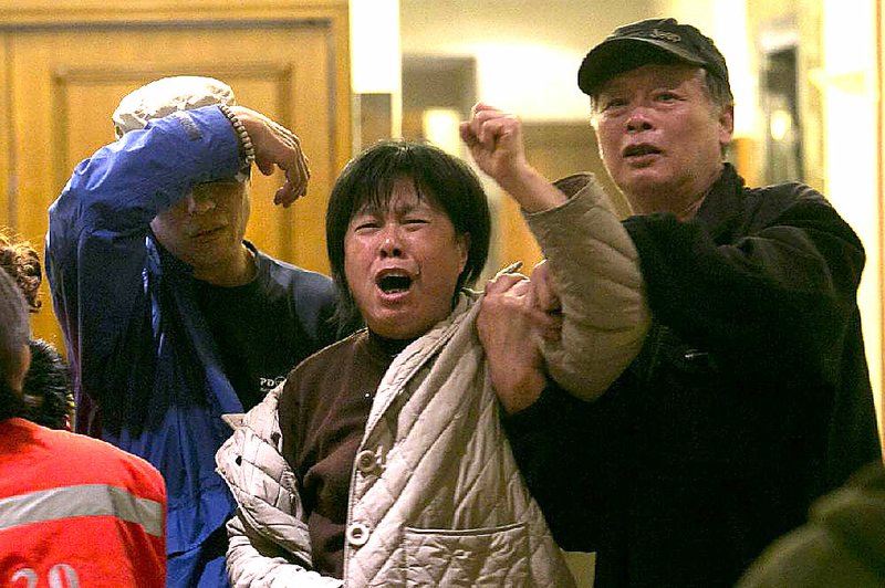A relative of one of the Chinese passengers aboard the Malaysia Airlines, MH370 grieves after being told of the latest news in Beijing, China, Monday, March 24, 2014. A new analysis of satellite data indicates the missing Malaysia Airlines plane crashed into a remote corner of the Indian Ocean, Malaysian Prime Minister Najib Razak said Monday. Malaysia Airlines said in a statement to the families that "our prayers go out to all the loved ones of the 226 passengers and of our 13 friends and colleagues at this enormously painful time." (AP Photo/Ng Han Guan)