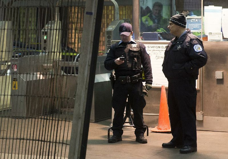 Chicago Police work the scene where a Chicago Transit Authority derailed at the O'Hare Airport station early Monday, March 24, 2014, in Chicago. More than 30 people were injured after the eight-car train plowed across a platform and scaled an escalator at the underground station. (AP Photo/Andrew A. Nelles)