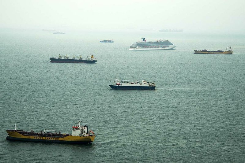 Dozens of ships sit idle off the coast of Galveston, Texas on Sunday, March 23, 2014. At least 33 vessels, including two cruise ships, are waiting to enter the Houston Ship Channel from the Gulf of Mexico after a ship and barge collided near the Texas City dike on Saturday afternoon. (AP Photo/ Houston Chronicle, Smiley N. Pool)