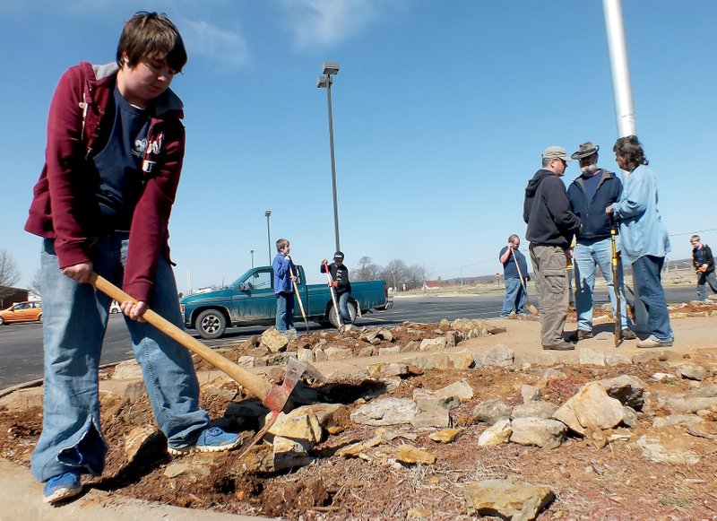 TIMES photograph by Annette Beard Peter Harris, front, was joined by members of his Boy Scout troop on his Eagle Scout project at Pea Ridge High School Saturday. Some of those helping included from left: Kamren Barrows, Daniel Pluenneke, Lee Stidham, Joe Miller, scout master John Sullivan, Nicole Harris and Seth Rippetoe.