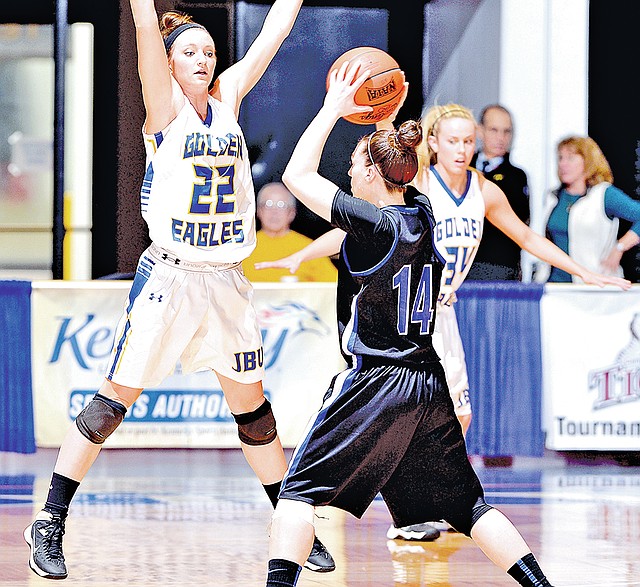 Special To NWA Media JBU Sports Information Sierra Shipley, John Brown guard, defends against an Oklahoma City ball handler during Monday's NAIA National Tournament Fab Four game at FRANKFORT, Ky. JBU lost 67-65. 