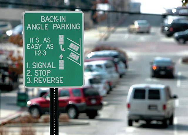 STAFF PHOTO DAVID GOTTSCHALK Cars are parked backed-in and at an angle Tuesday on Block Avenue in Fayetteville. The City Council's Transportation Committee considered two options for eliminating the back-in parking on Block Avenue that exists between Dickson and and Spring streets.