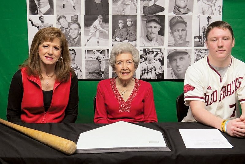 Two Rivers High School student Austin Long sits with Oleta Baskin of Casa, center, widow of the late minor league baseball player Bill Baskin, and the Baskins’ daughter, Patti Baskin, also of Casa. In addition to being a minor league baseball player, Bill Baskin was superintendent of the Casa School District for 41 years. Long is a member of a high school class that has created the Arkansas Online Baseball Museum.