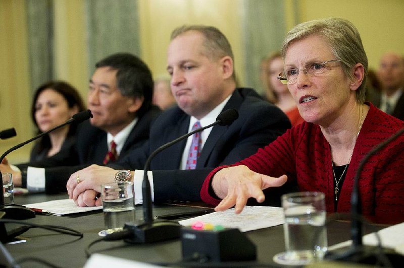 Ellen Richey, chief legal officer of Visa Inc., responds to a question Wednesday during a Senate hearing on Target’s data breach. At the table with Richey are John Mulligan (second from right), chief financial officer of Target Corp., Wallace Loh, president of the University of Maryland, and Edith Ramirez, chairman of the Federal Trade Commission. 