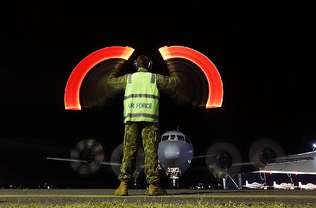 An Australian air force AP-3C Orion returns Wednesday to its base in Bullsbrook after helping search the southern Indian Ocean for Malaysia Airlines Flight 370. Aircraft and ships from six countries are searching for the lost airliner. 