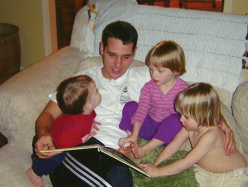 COURTESY PHOTO 
Cameron, in the striped shirt, snuggles for story time with dad Derrick Bobbitt, her sister Kennedy, far right, and cousin Eaton in a photo from 2004.