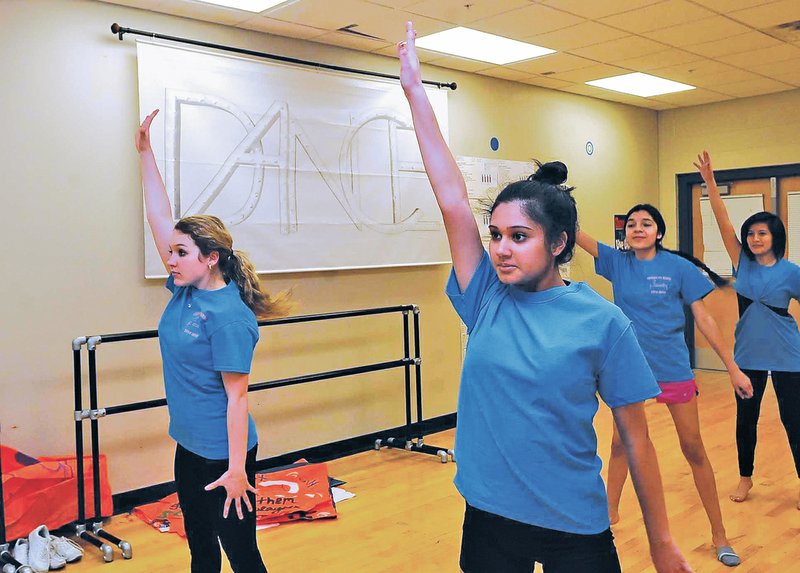 STAFF PHOTO FLIP PUTTHOFF THEATER DANCE Jenna Leavitt, from left, Ruchika Gorgia, Beatriz Melchor and Mary Chavez practice a theater-dance routine March 20 at Heritage High School in Rogers. The students are preparing for a dance performance April 6.