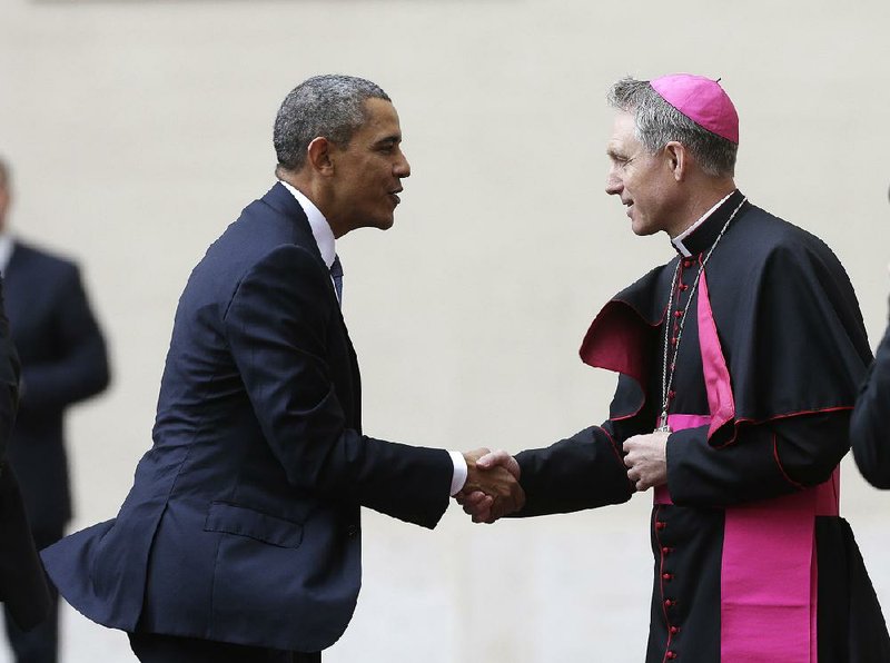 President Barack Obama is welcomed by Archbishop George Gaenswein, prefect of the papal household, as he arrives Thursday at the Vatican to meet Pope Francis. 