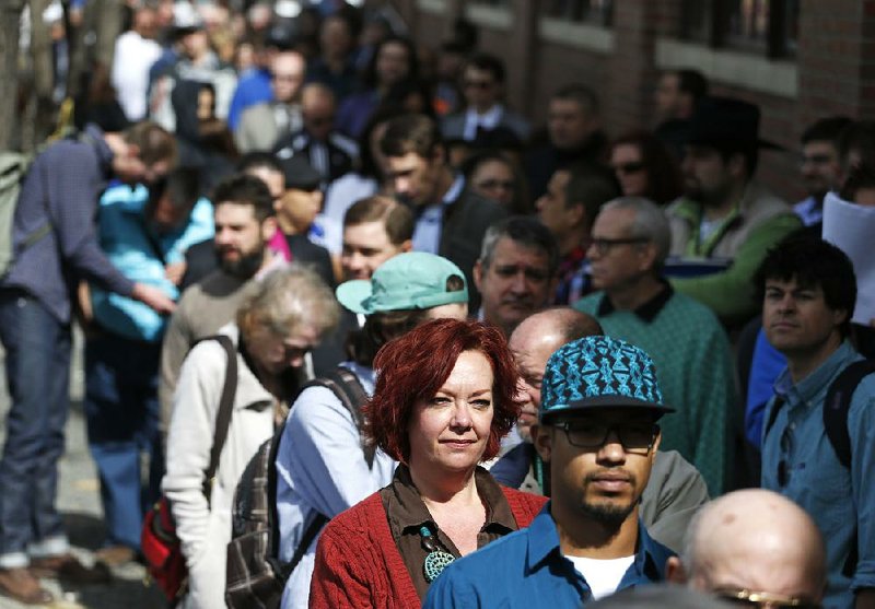 FILE - In this Thursday March 13, 2014, file photo, Job seekers line up in the hundreds to attend a marijuana industry job fair hosted by Open Vape, a vaporizer company, in Downtown Denver. The Labor Department releases weekly jobless claims on Thursday, March 27, 2014. (AP Photo/Brennan Linsley, File)