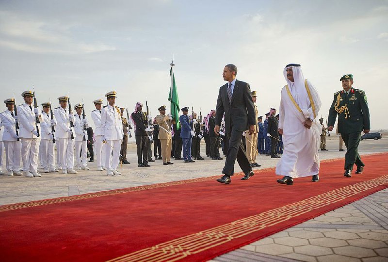 US President Barack Obama walks past honor guard with Governor of Riyadh Prince Khalid Bandar bin Abdul-Aziz Al-Saud on arriving at King Khalid International airport in Riyadh, Saudi Arabia, Friday, March 28, 2014. (AP Photo/Pablo Martinez Monsivais)