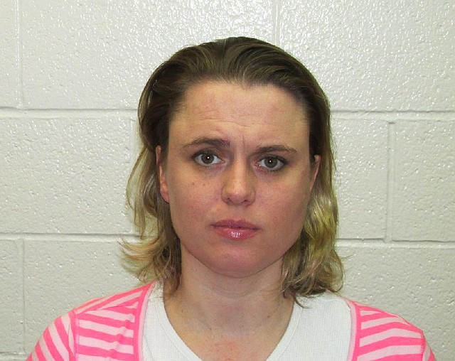 Accompanied by her attorney, Andrea Davis, 36, appeared at the Garland County sheriff’s office and was arrested and charged with manslaughter in the slaying of Maxwell Anderson. 