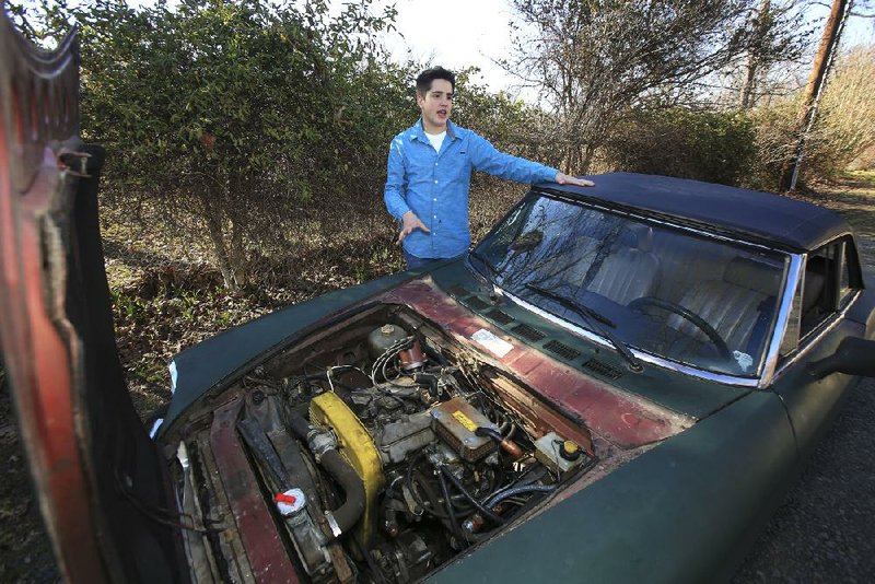 Arkansas Democrat-Gazette/STATON BREIDENTHAL --3/18/14-- Kenneth Carper, 14, explains all the work he and his father have done to a 1979 Fiat Spyder to get the car in working condition. 